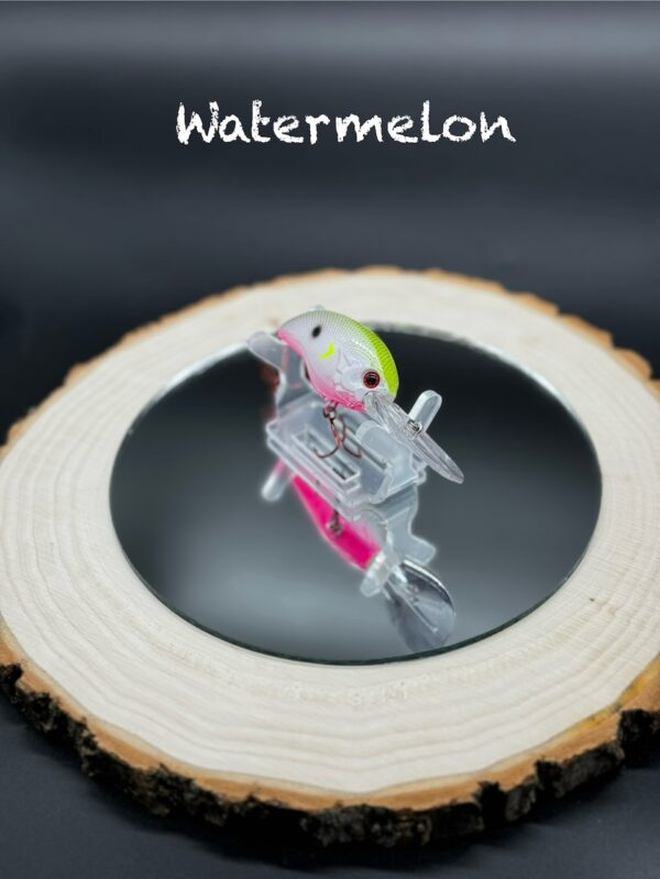 A white fishing lure with a bright green back and hot pink belly under the title "Watermelon".