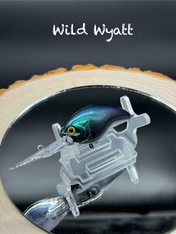 A fishing lure painted in a green-blue-black gradient under the title "Wild Wyatt".