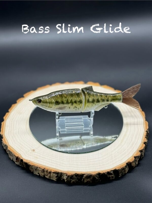 A fishing lure painted various shades of green under the title "Bass Slim Glide".