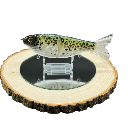 A green and yellow fishing lure with black speckles.