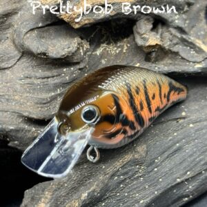 A brown and orange squarebill lure with black markings under the title "Prettybob Brown".