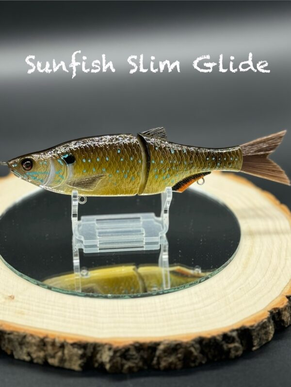 A green fishing lure with subtle teal spots under the title "Sunfish Slim Glide".