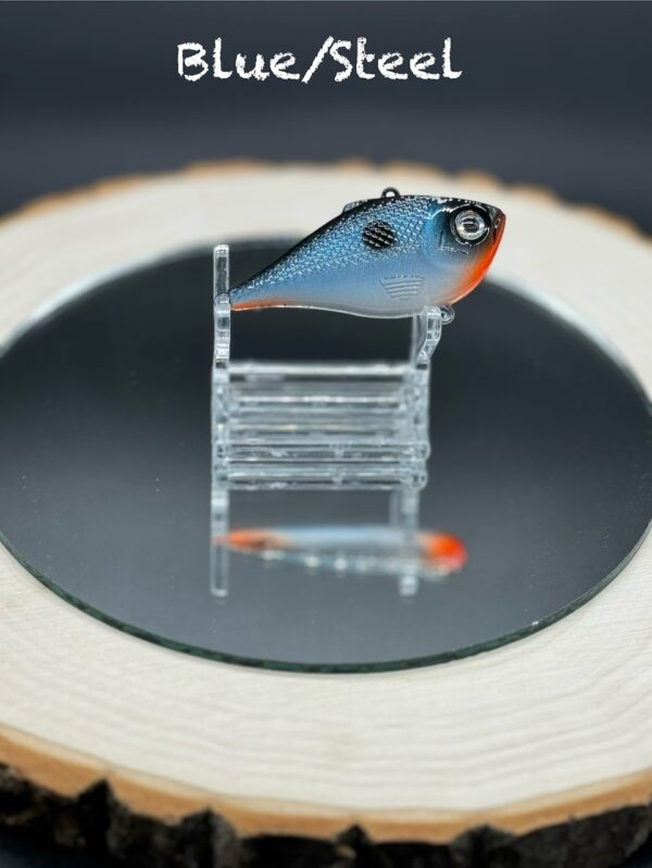 A 60mm lipless lure under the title "Blue/Steel" painted steel blue with orange and black accents.