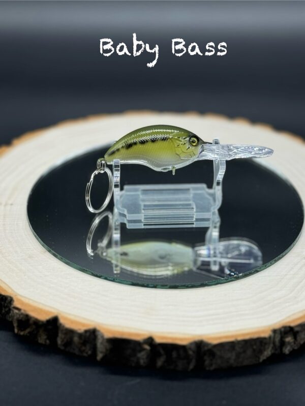 A keychain lure under the title "Baby Bass" painted green with black accents.